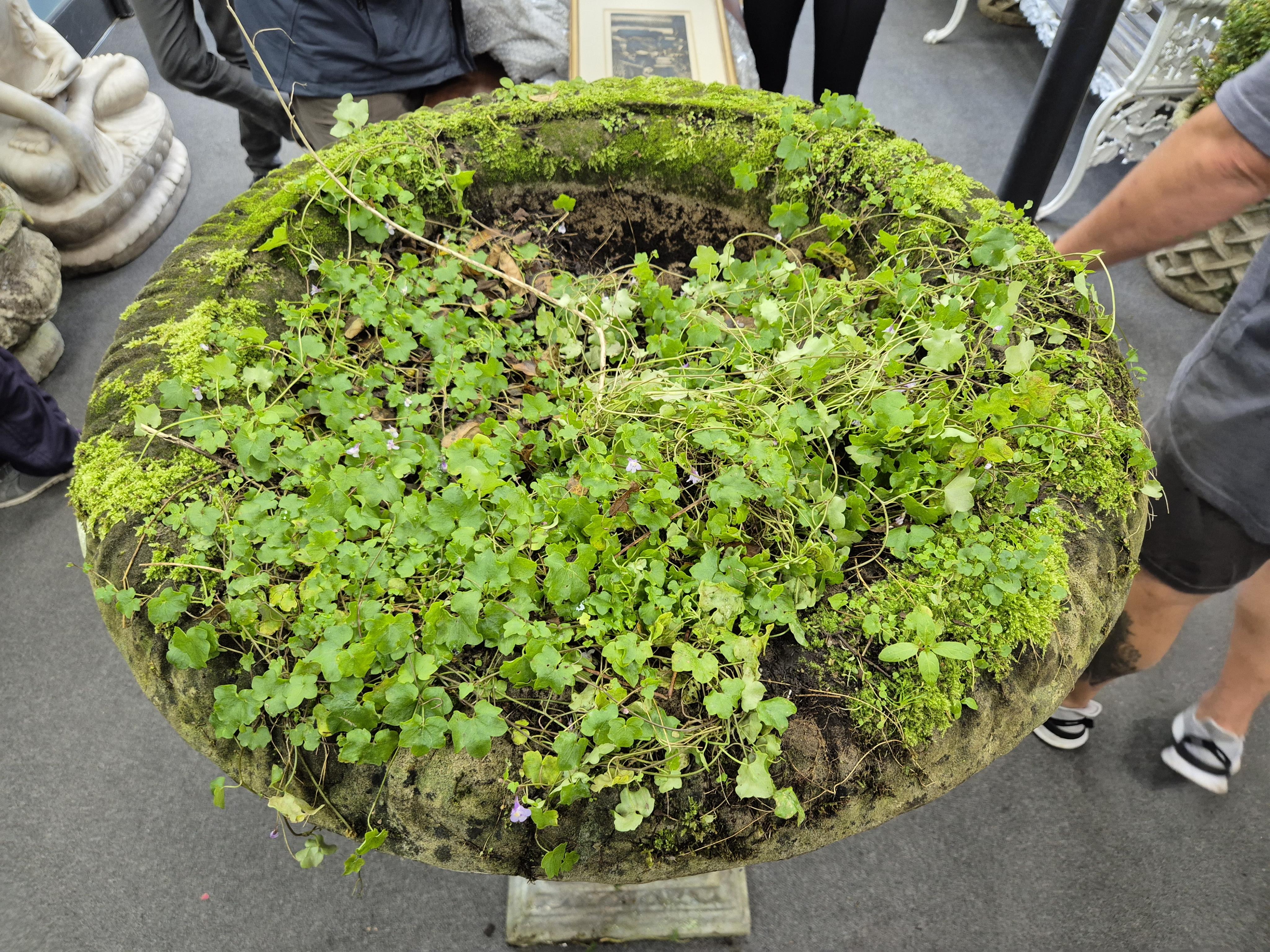 A large reconstituted stone garden vase